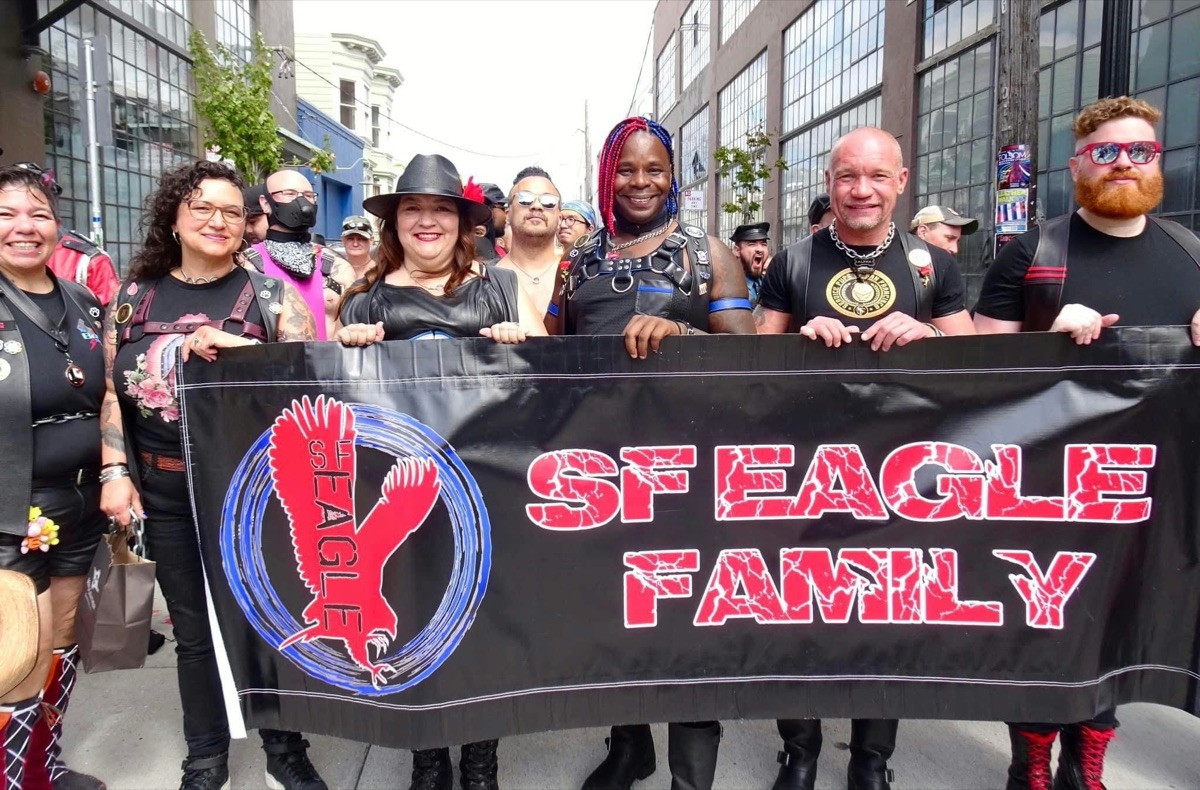 The SF Eagle family holding their banner at Leather Pride